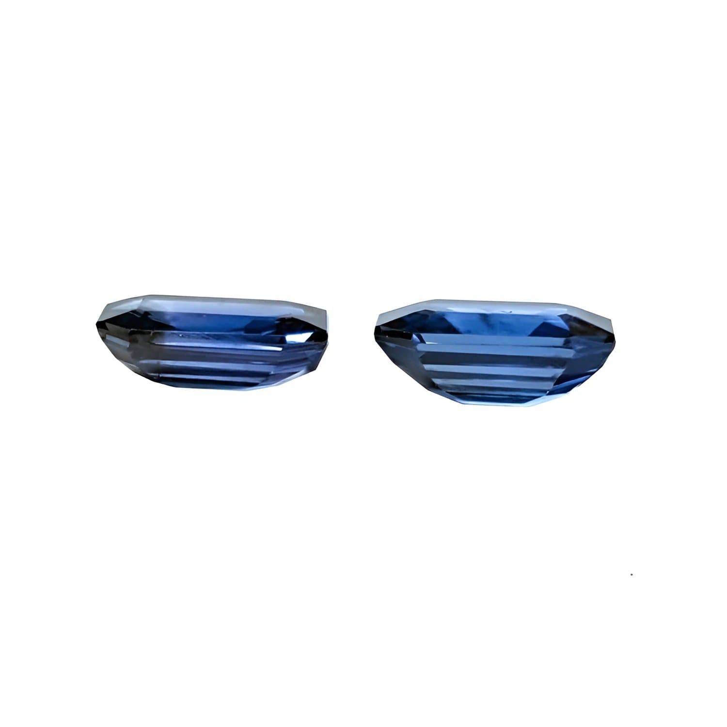 Matching pair of 2.09 ct. emerald-cut blue sapphires, ideal for earrings.