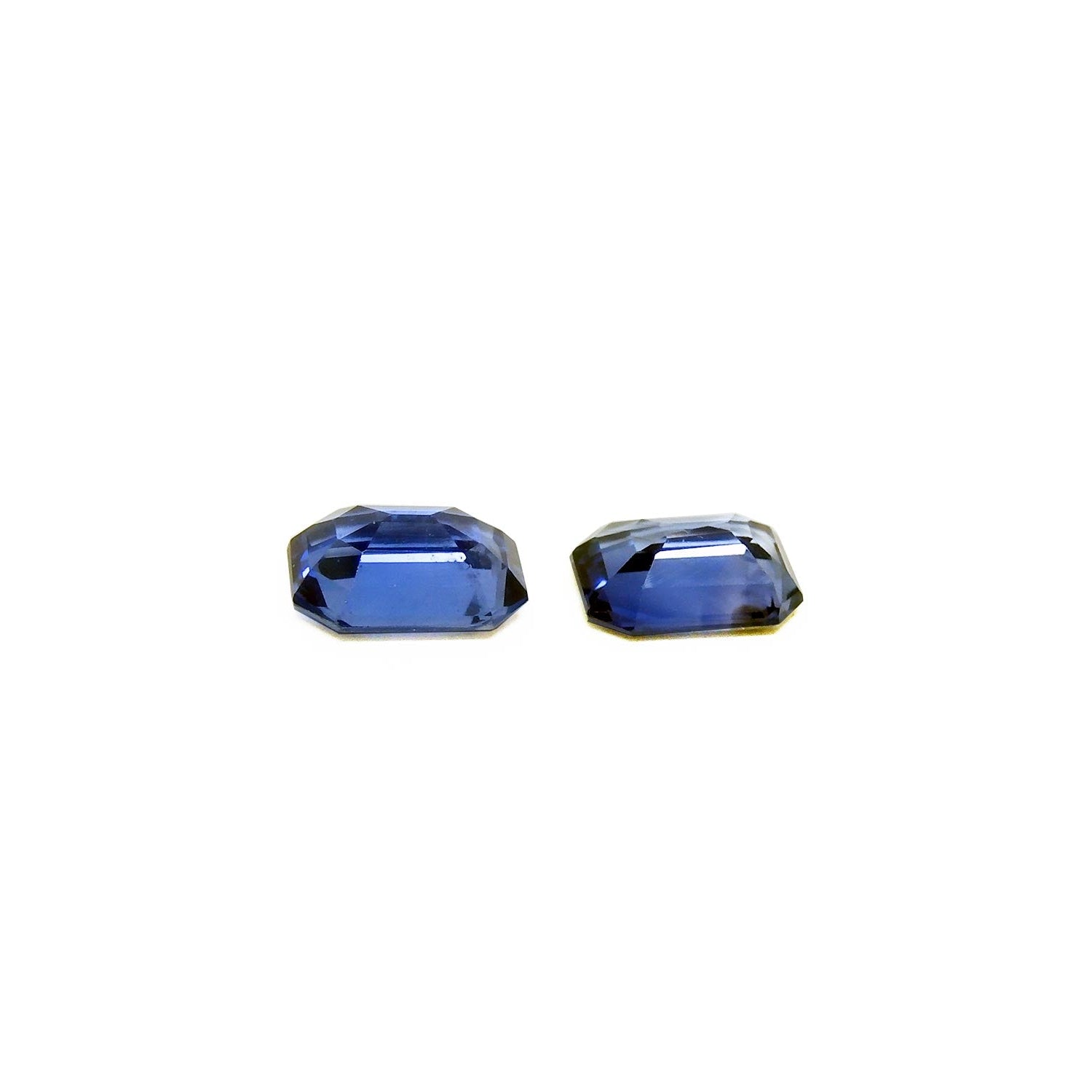 Natural blue sapphires matching pair emerald-cut for earrings, upside down exposing pavilions