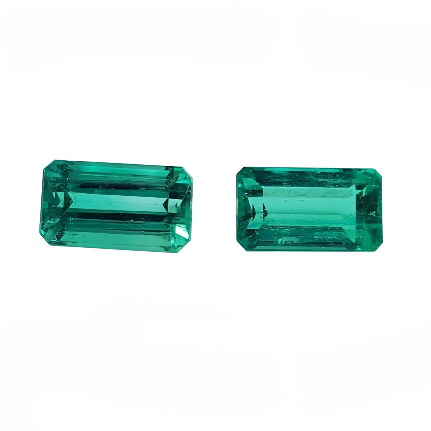 Matching pair of emerald-cut 3.38 ct. loose emeralds, vibrant bluish medium deep green.