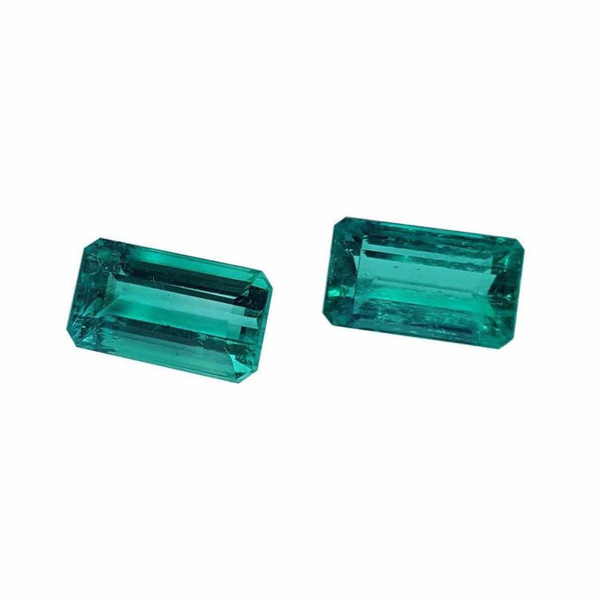Matching pair of emerald-cut 3.38 ct. loose emeralds, fine quality, vibrant bluish medium deep green.