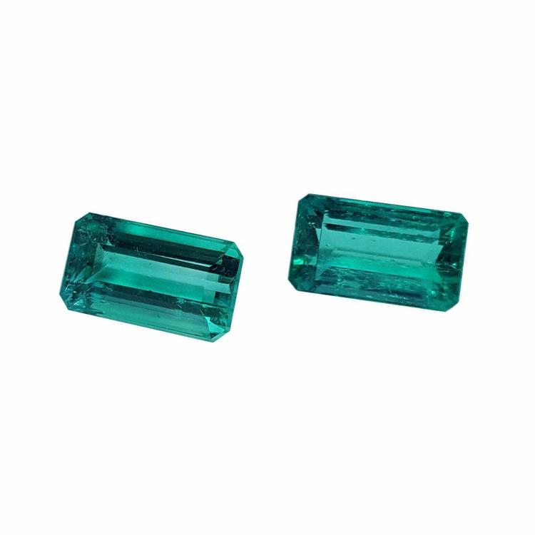 Matching pair of emerald-cut 3.38 ct. loose emeralds, fine quality, vibrant bluish medium deep green.