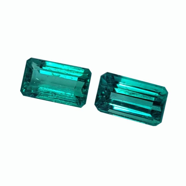 Emerald-cut matching pair loose natural emeralds from Muzo Colombia, eye clean vibrant bluish medium deep green color.