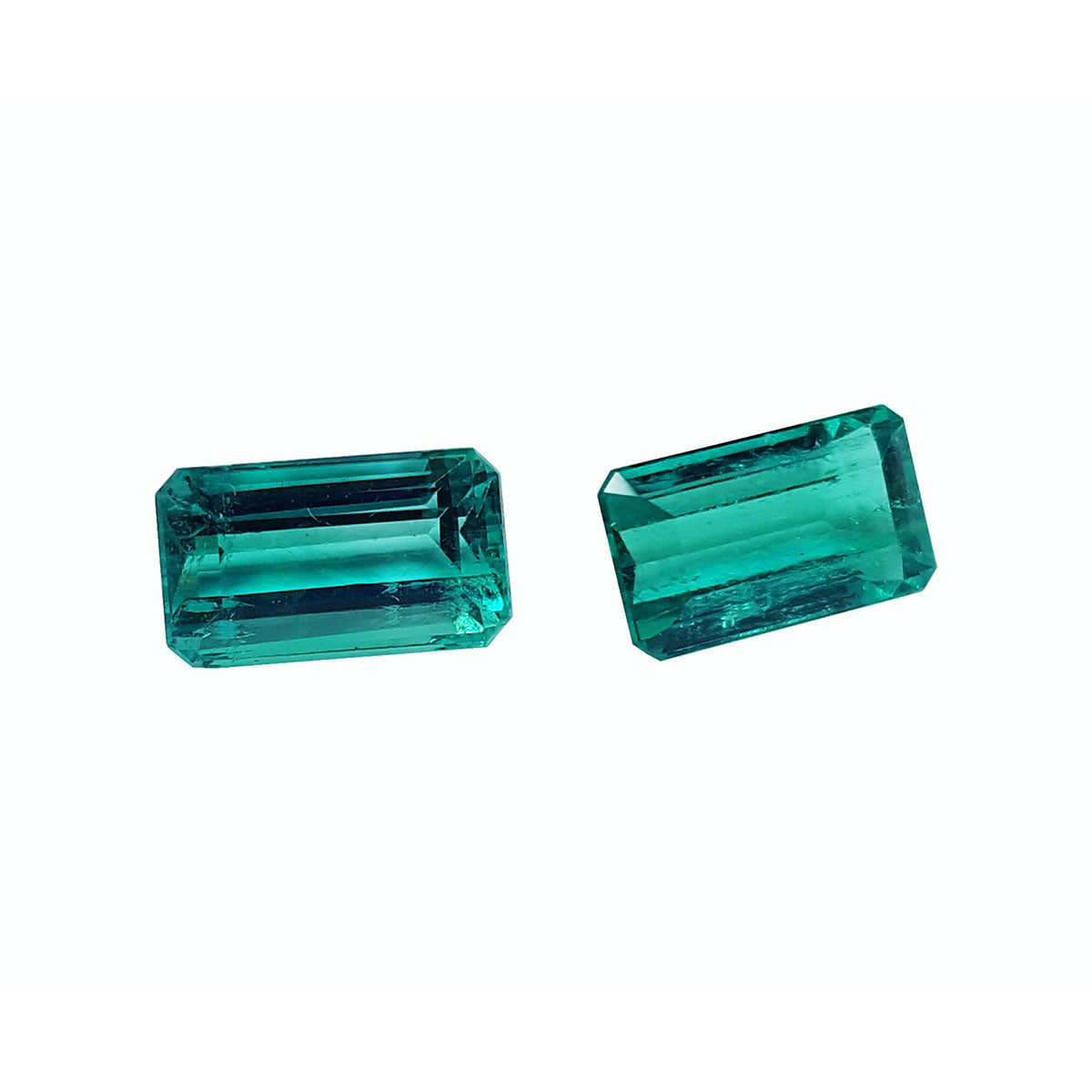 Emerald-cut matching pair loose emeralds from Muzo Colombia, right side tables and crowns exposed