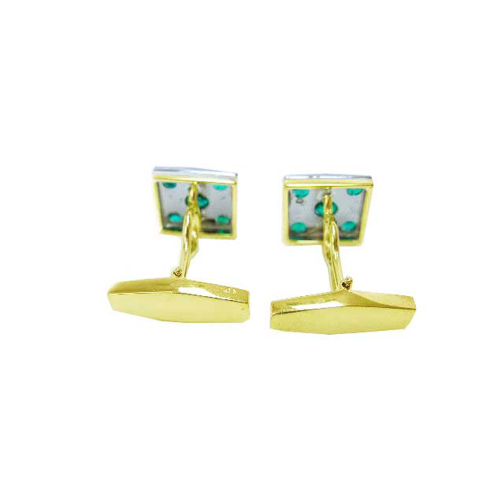 Gold cufflinks with colombian emeralds showing the underside profile on a white background
