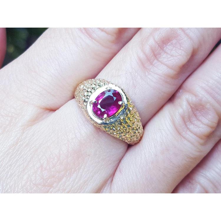 Men's natural oval ruby ring unisex-solitaire yellow gold, front top view on a person's finger