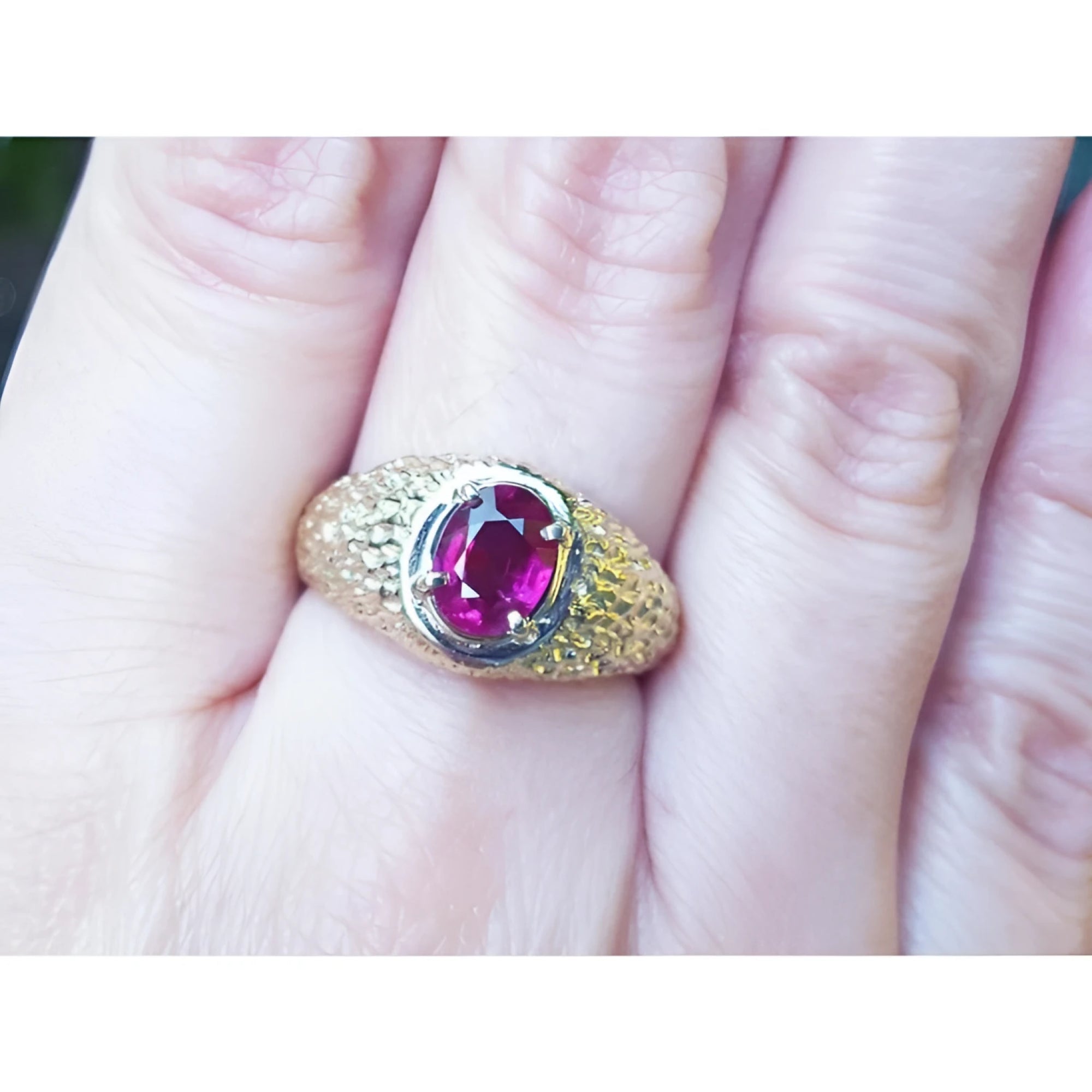 Men's 18K yellow gold ring with a sparkling pinkish-red oval cut Burma ruby, prong-set.