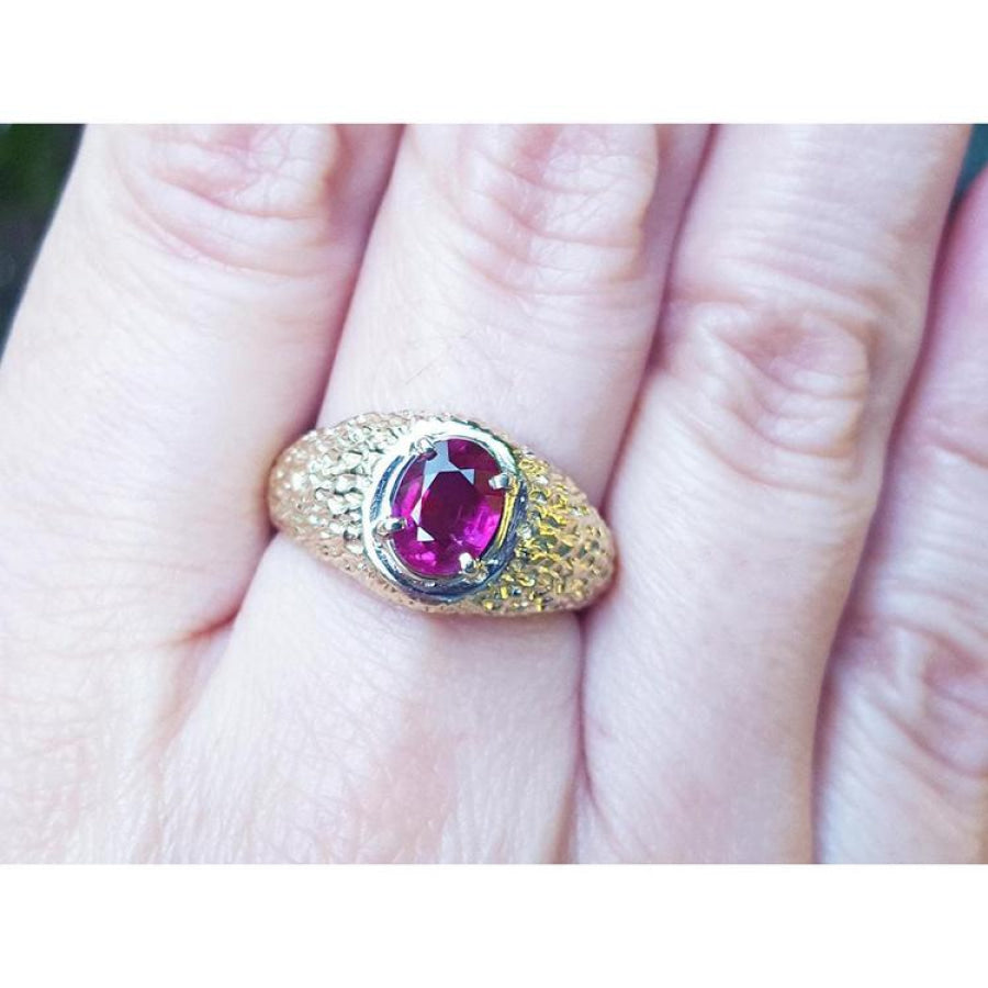 Men's 18K yellow gold ring with a sparkling pinkish-red oval cut Burma ruby, prong-set.