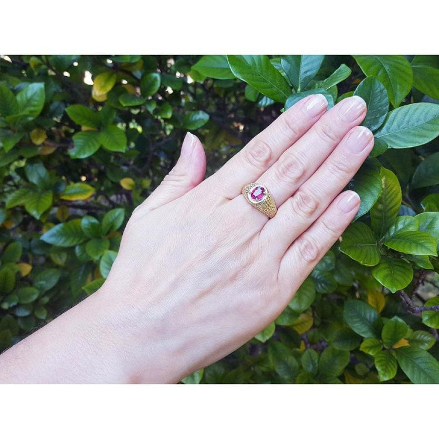Men's 18K yellow gold ring with a prong-set oval pinkish-red Burma ruby.