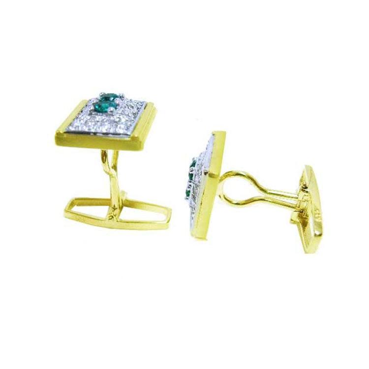 The lateral view of a pair of yellow gold cufflinks with genuine emeralds and diamonds.