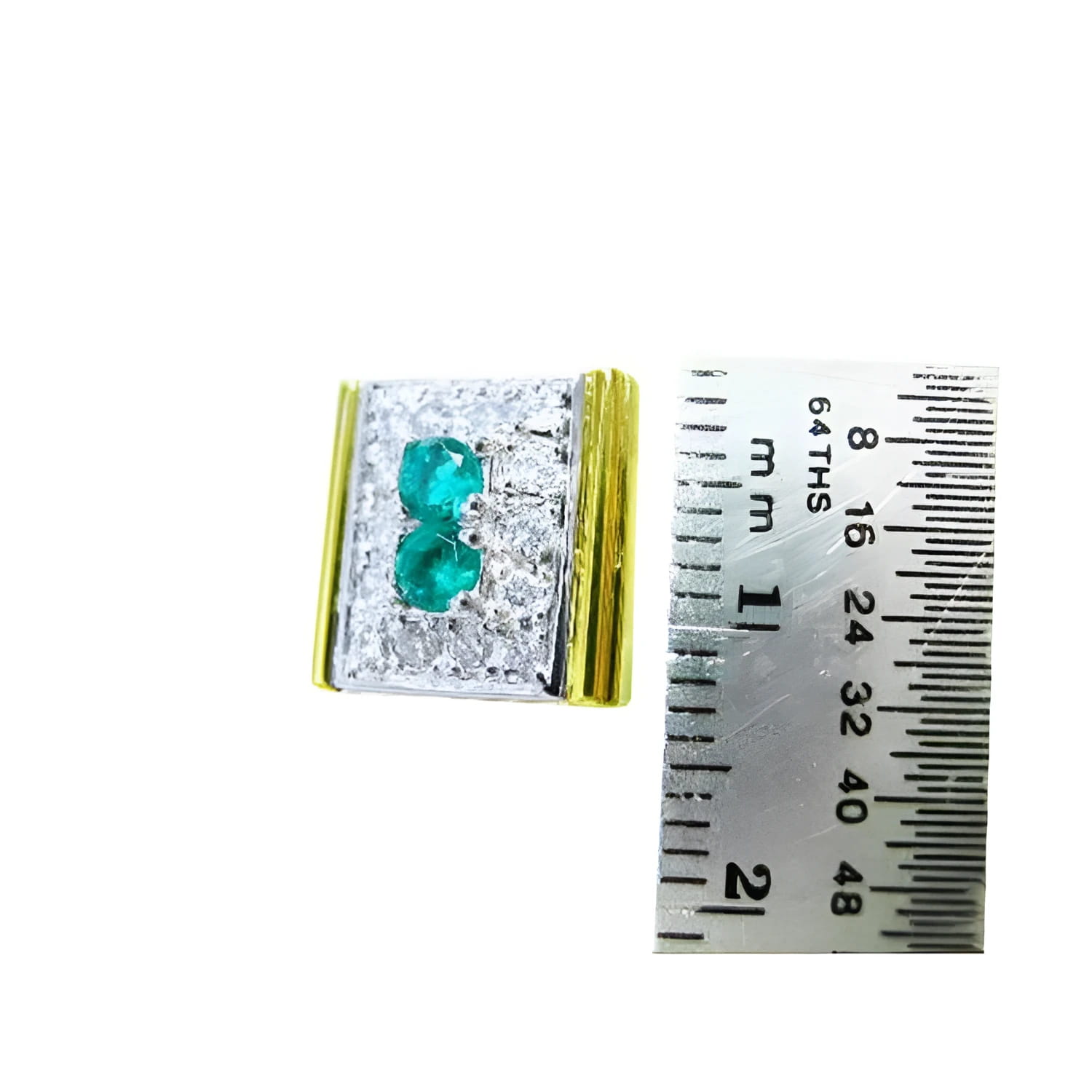 14K yellow gold men's cufflinks with two emeralds surrounded by diamonds, next to a ruler.