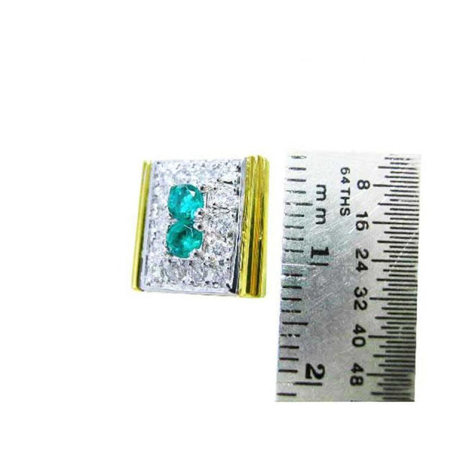 14K yellow gold men's cufflinks with two emeralds surrounded by diamonds, next to a ruler.
