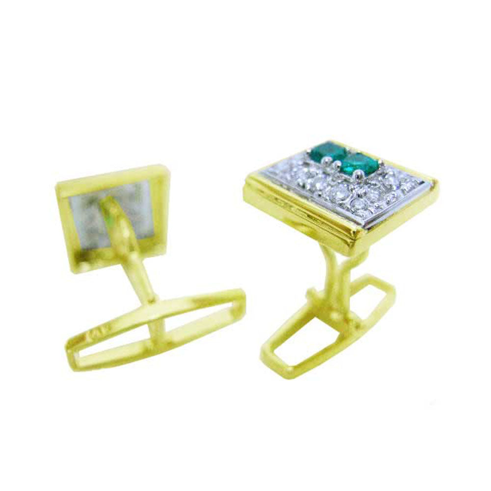 The underside view of a pair of cufflinks in yellow gold with real emeralds and diamonds.