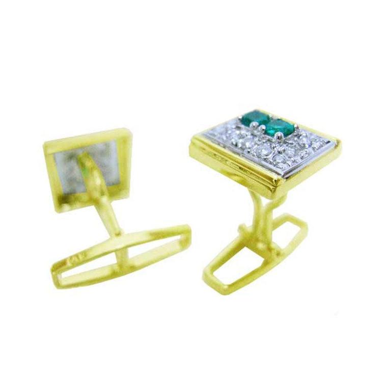 The underside view of a pair of cufflinks in yellow gold with real emeralds and diamonds.