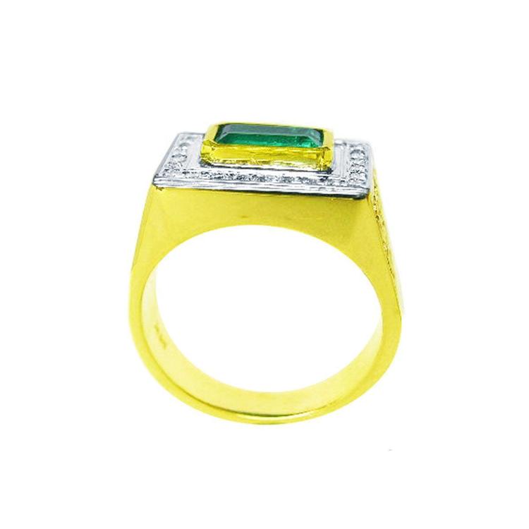 Gold ring for man with a rectangular emerald and diamond accents on a white background
