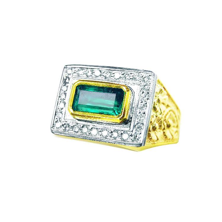 Gold and white ring for men with a natural emerald on a white background