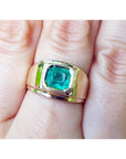 Gold solitaire ring for men with a square natural colombian emerald on a hand.