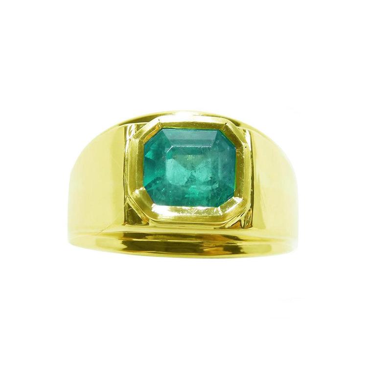 A Men's emerald solitaire ring bezel set 14k yellow gold displaying the topside view.