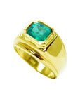 This men's emerald solitaire gold ring with a bezel set displays its top and side profile view.