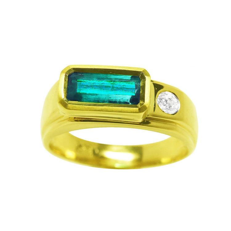 The topside view of a yellow gold men's ring with a rectangular natural colombian emerald bezel set and one accent diamond.