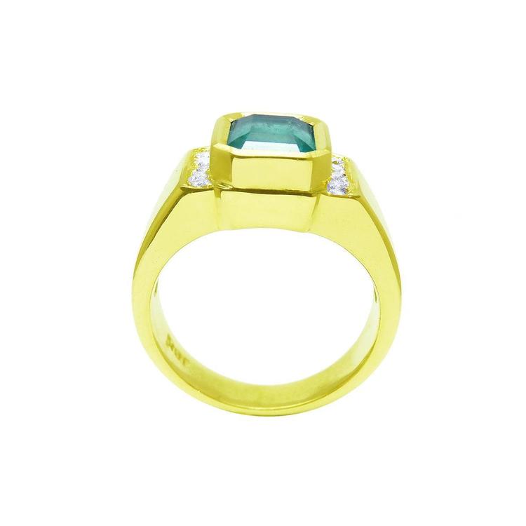 Gold ring with a natural colombian emerald and diamond accents on a white background.