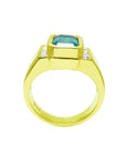 Gold ring with a natural colombian emerald and diamond accents on a white background.
