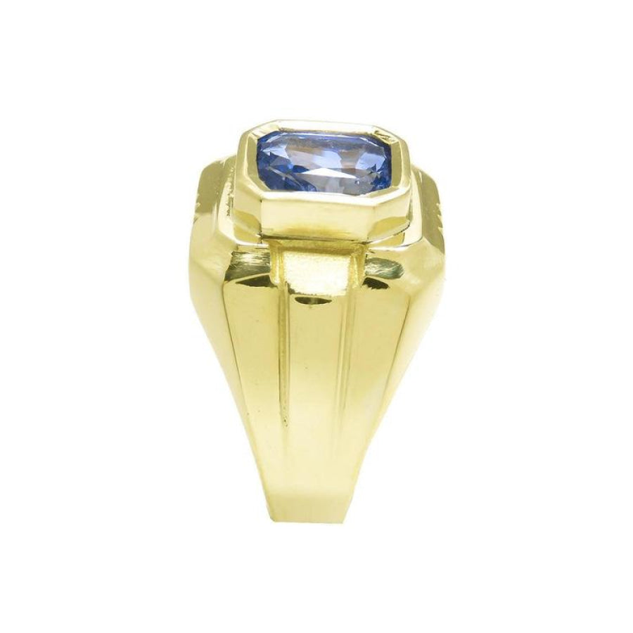 Men's 18K yellow gold ring with a bezel-set, octagonal vivid blue sapphire.