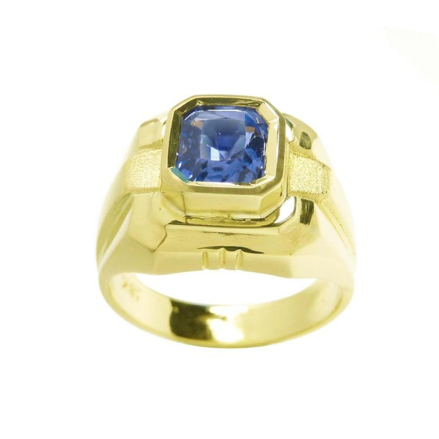 Men's 18K yellow gold solitaire ring with a vivid blue octagonal sapphire.