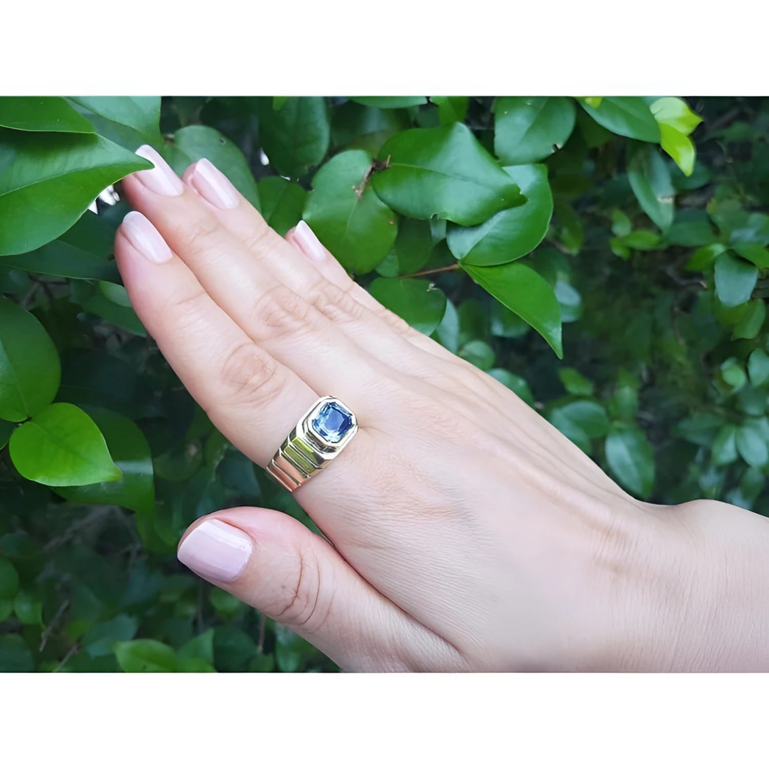 Men's 18k yellow gold ring with a vibrant blue octagonal sapphire, bezel set east-west.