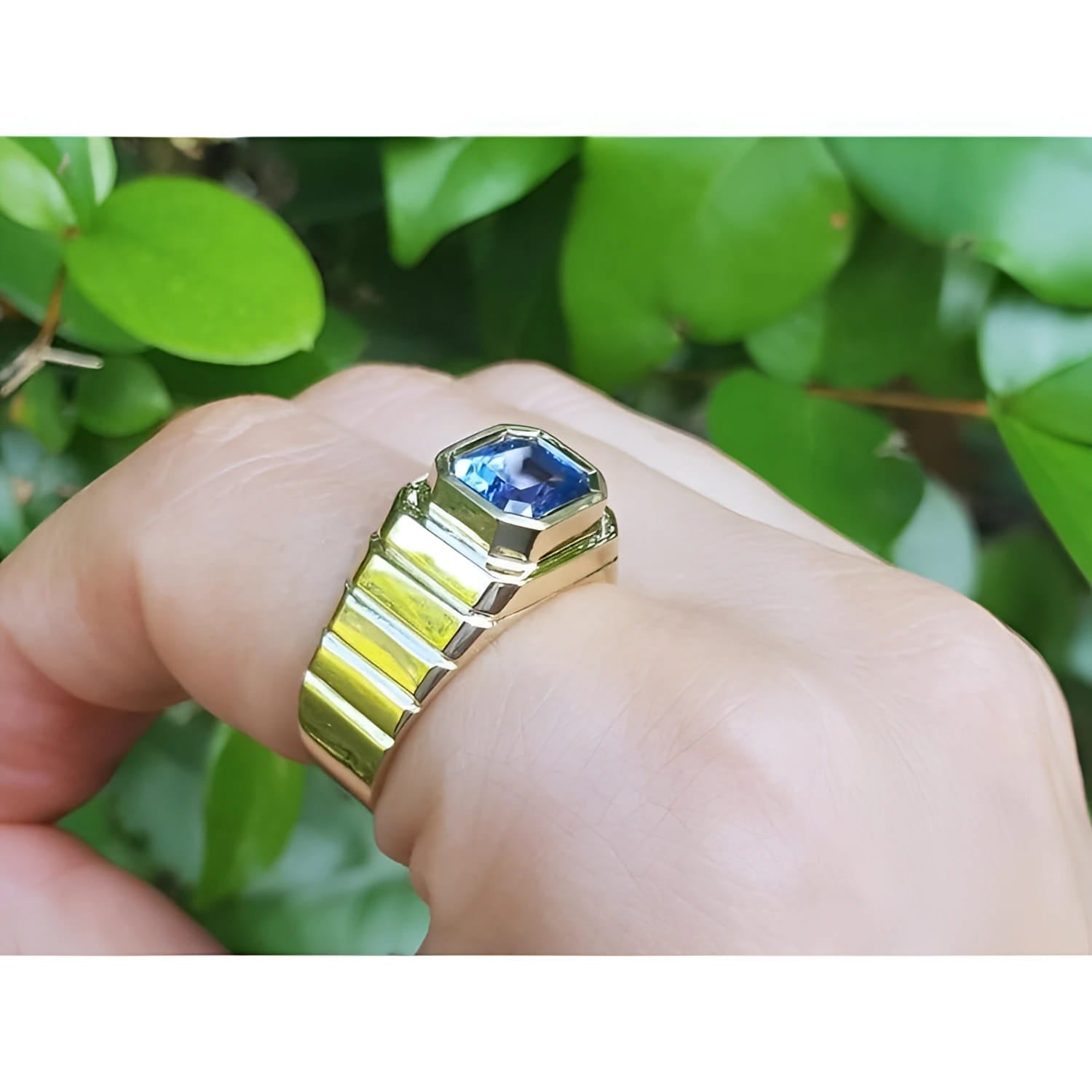 Men's 18k yellow gold ring with a bezel-set, octagonal blue sapphire.