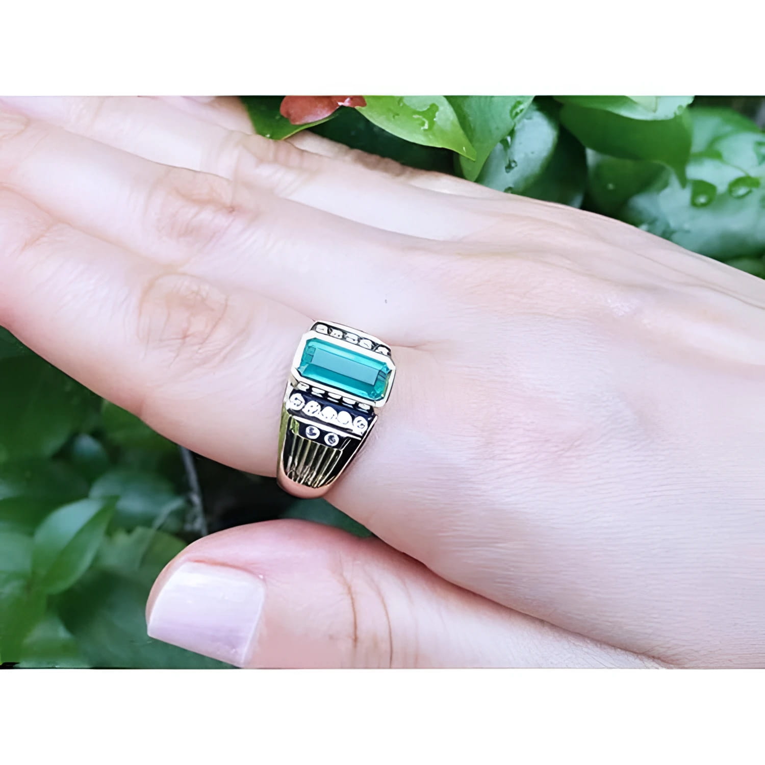 Men's 14K yellow gold ring with a rectangular Colombian emerald bezel set, flanked by burnish-set diamonds.