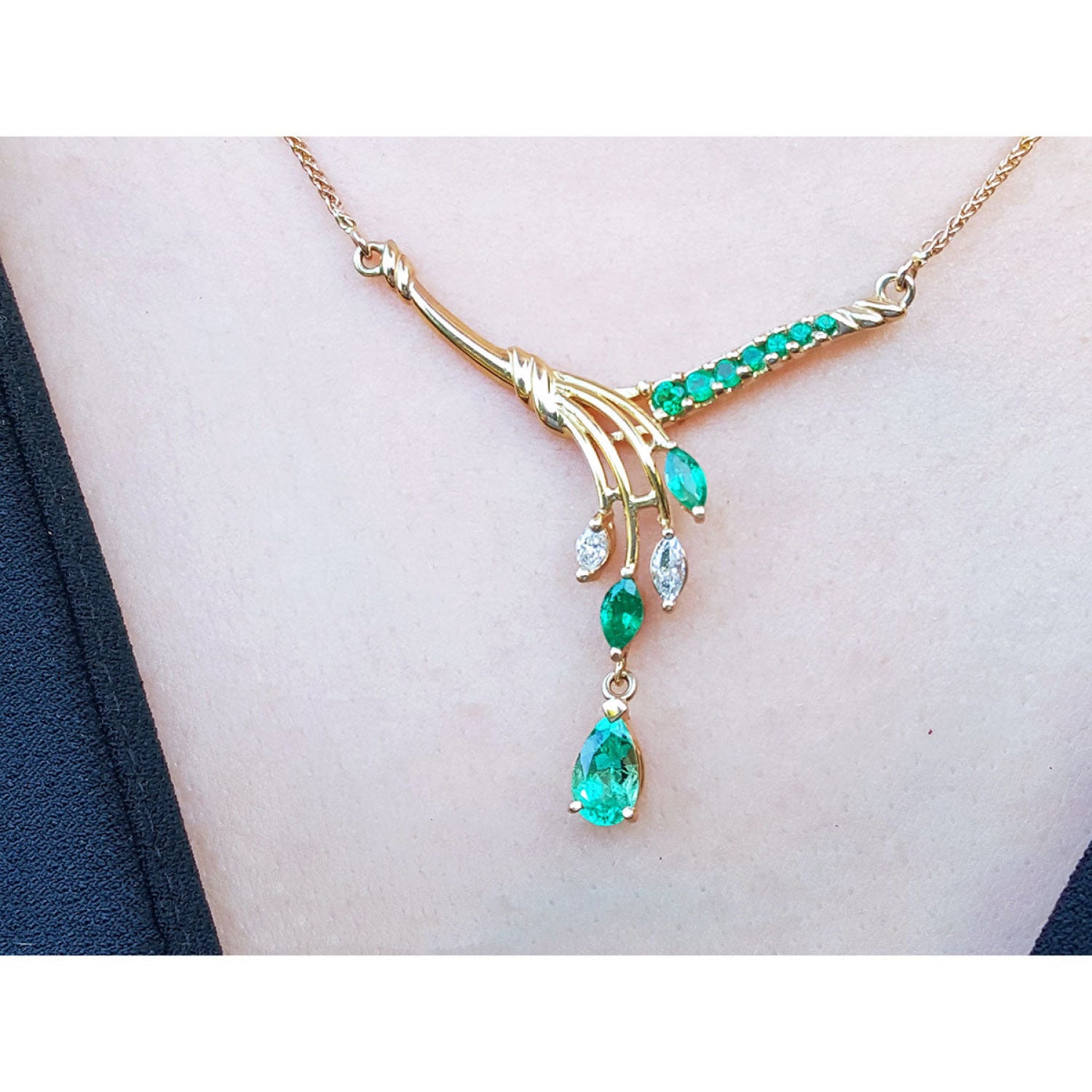 14K yellow gold necklace with marquise and pear shaped Colombian emeralds and diamonds.
