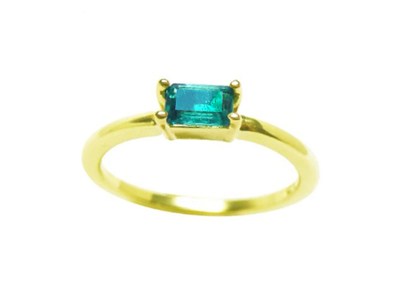 This minimalist solitaire emerald ring shows the topside profile.