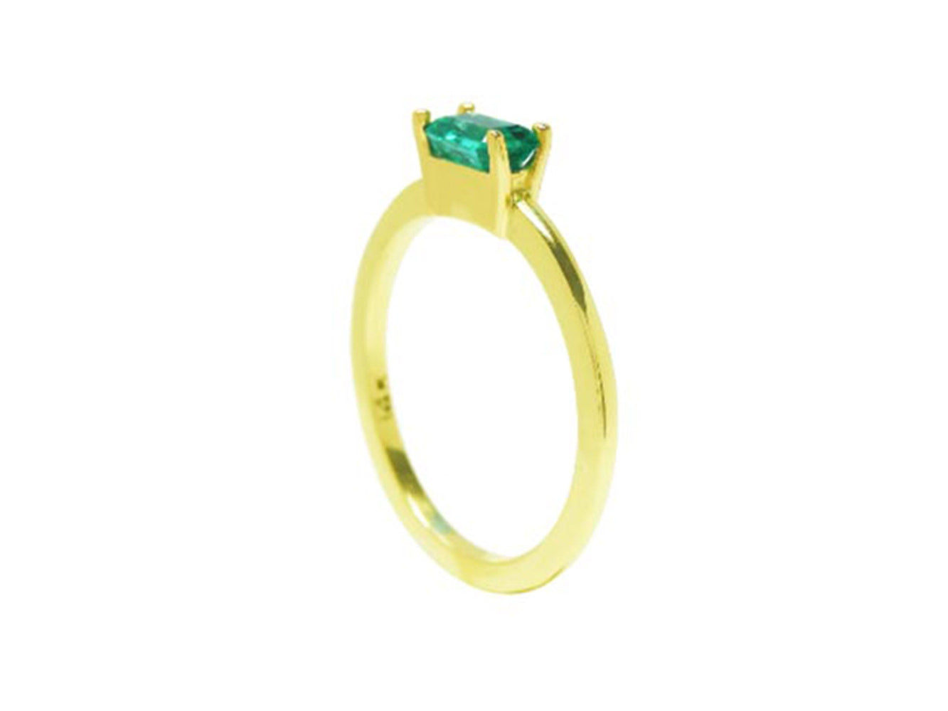 A yellow gold minimalist solitaire emerald ring in its side position.