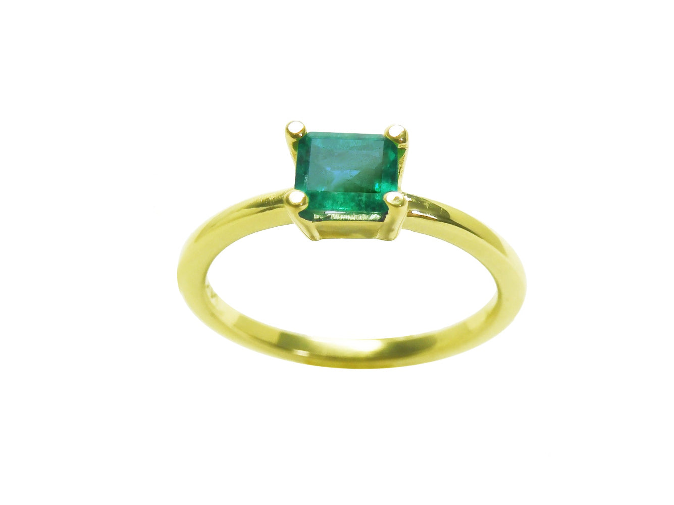 A minimalist emerald solitaire ring representing May's birthstone jewelry in 14k yellow gold.