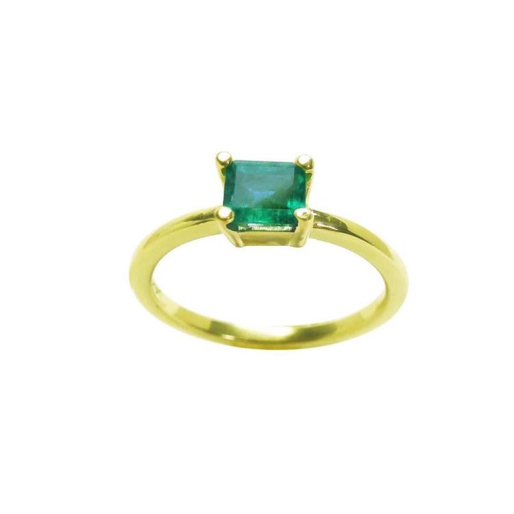 A minimalist emerald solitaire ring representing May's birthstone jewelry in 14k yellow gold.