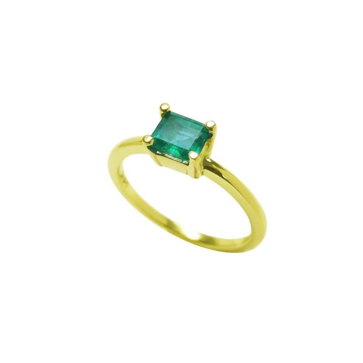 Tilted position for this minimalist emerald solitaire ring representing May's birthstone jewelry, topside and band ring profile visibles.