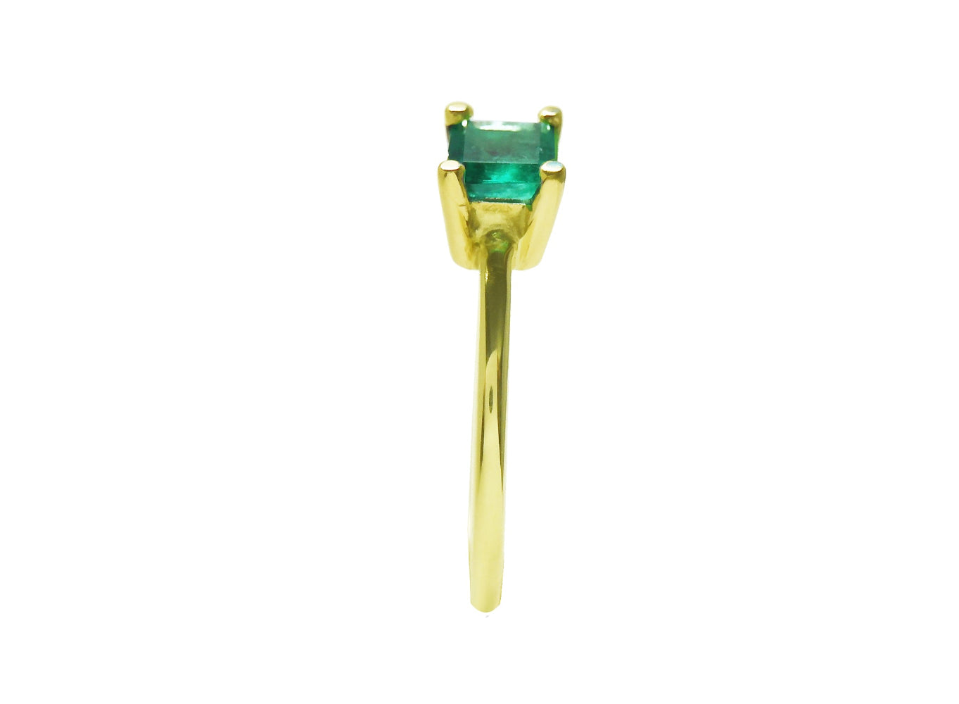 Side view of a minimalist emerald solitaire ring representing May&#39;s birthstone jewelry.