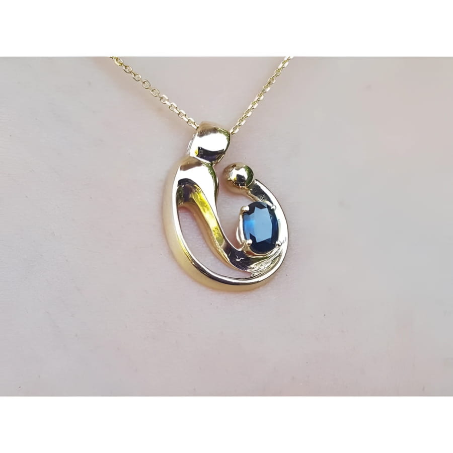 14K yellow gold mother and child slider pendant necklace with a deep blue sapphire.