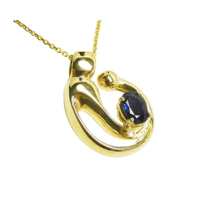 Right side top view of a mother and child sapphire necklace slider pendant crafted in 14k yellow gold