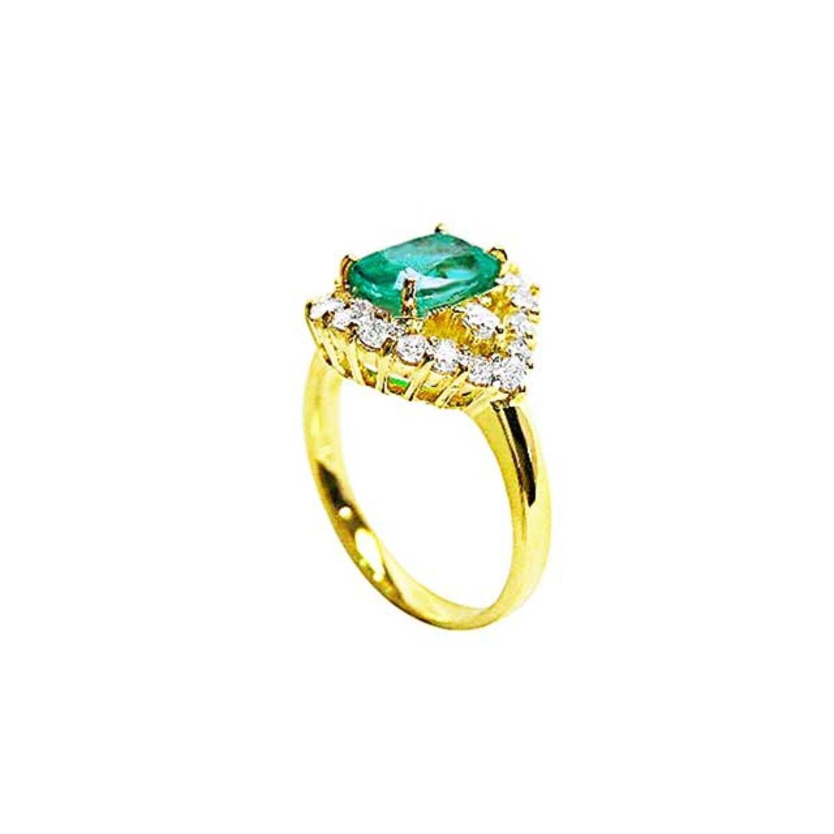 A cushion-cut Muzo Colombian emerald centerpiece ring encircled by diamonds, highlighting both the top view and the side profile of the band.