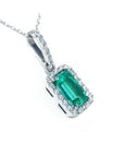 This Colombian emerald pendant with a halo diamond was made of 18k white gold.