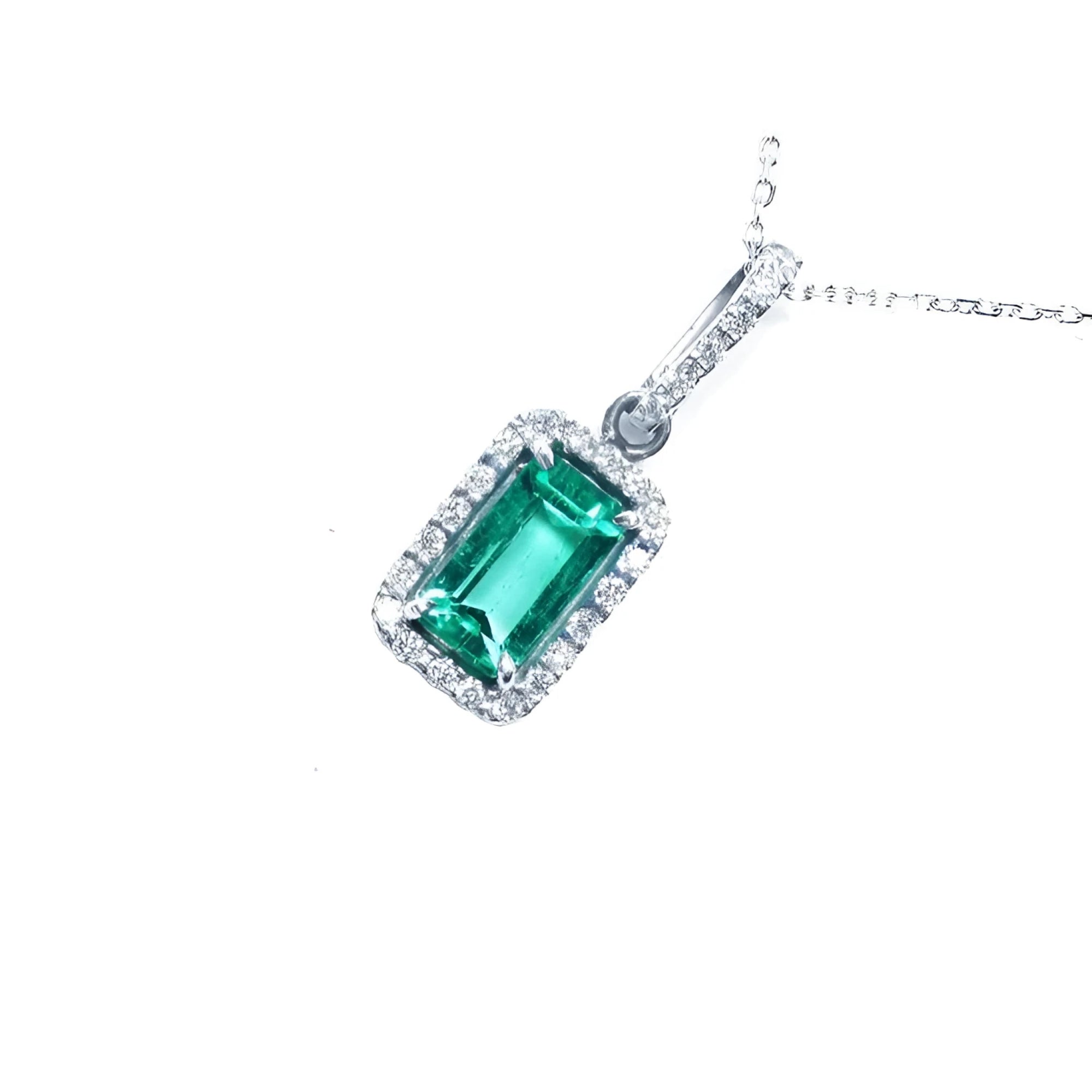 1.70 ct Muzo Colombian emerald pendant with diamond halo in 18K white gold.