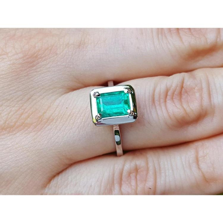 1.50 carat Muzo Colombian emerald solitaire ring in 18K white gold, rectangular cut.