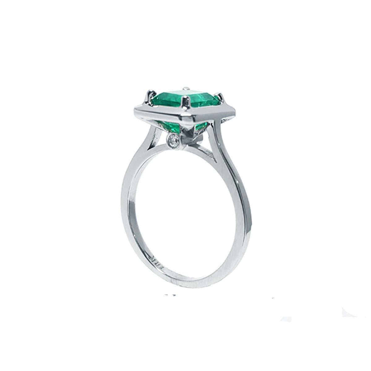 A half-side of this emerald solitaire ring shows the top and band profile on a white background.