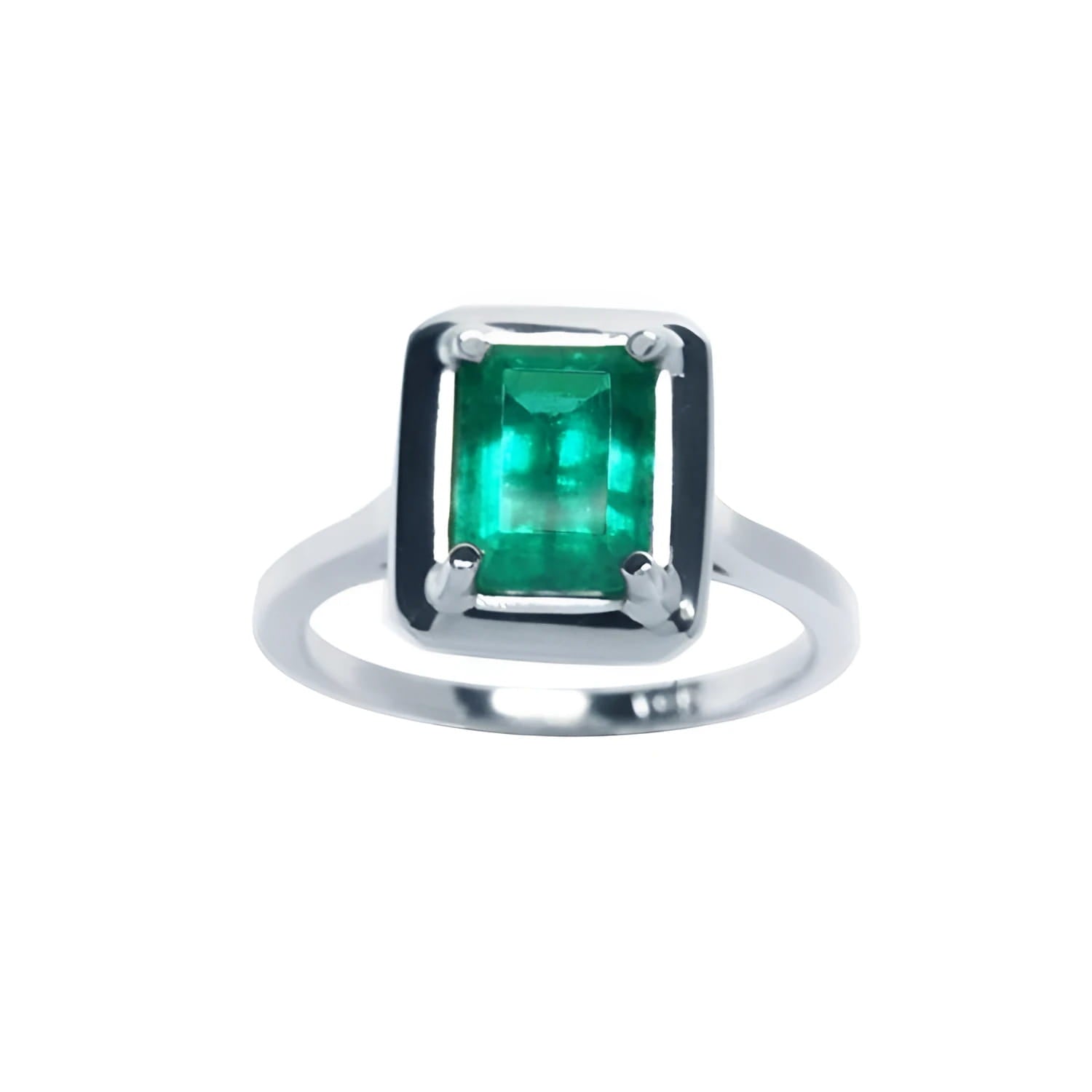 This Muzo Colombian emerald solitaire ring features a rectangular emerald-cut stone set in prongs of 18k white gold.
