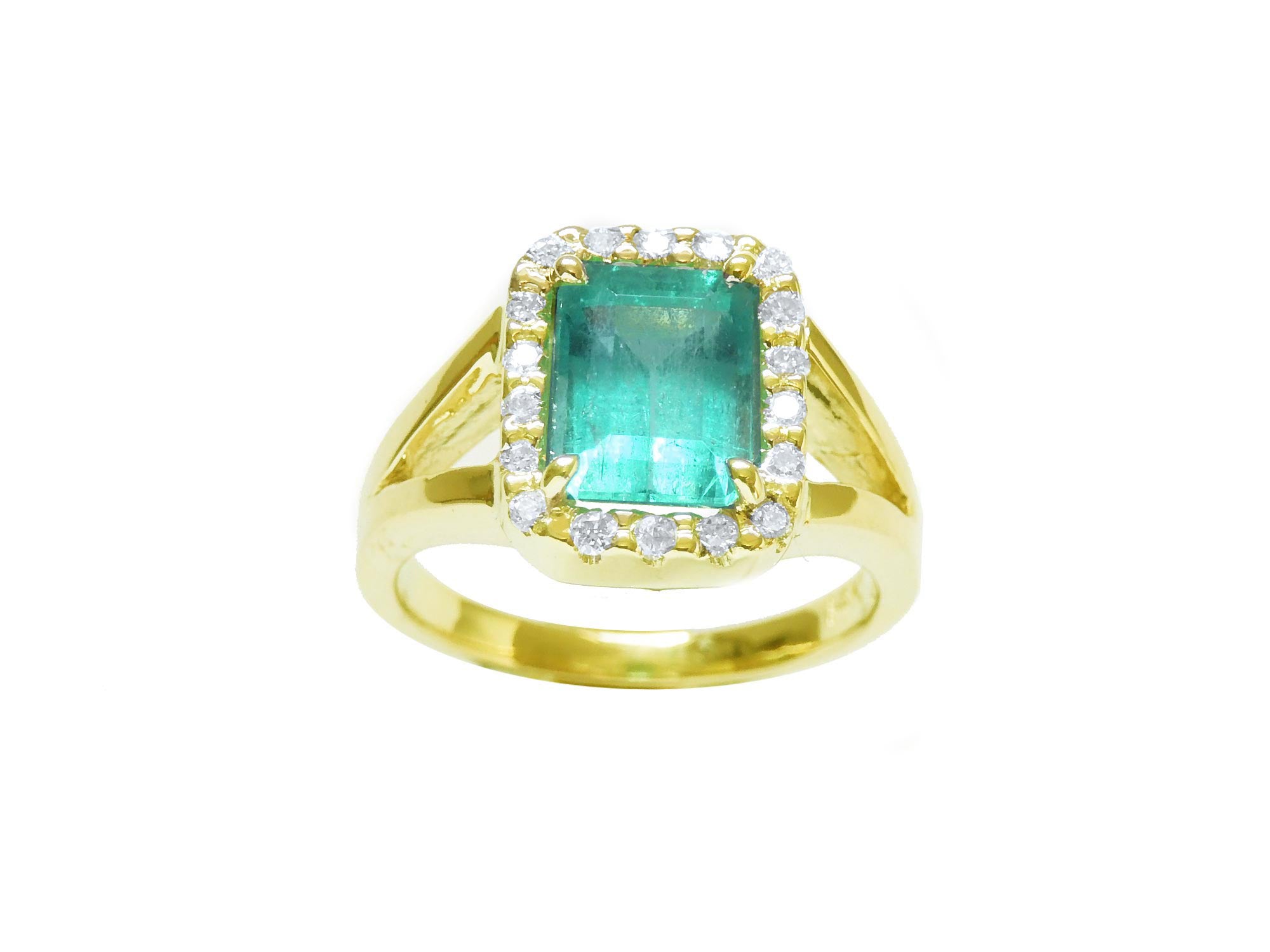 This emerald-cut Colombian emerald ring is on its front position and displays top and halo diamond view.