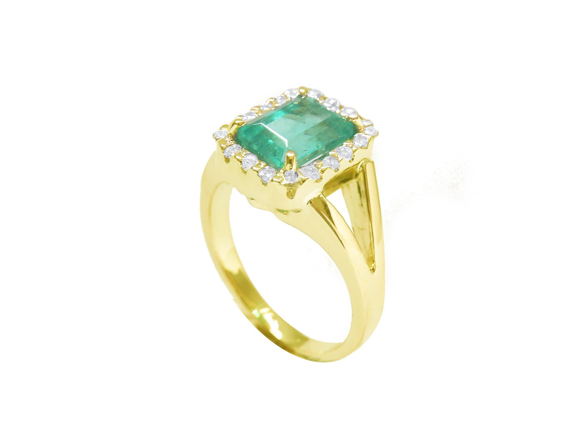 Half side profile displaying a yellow gold emerald ring with split shank.