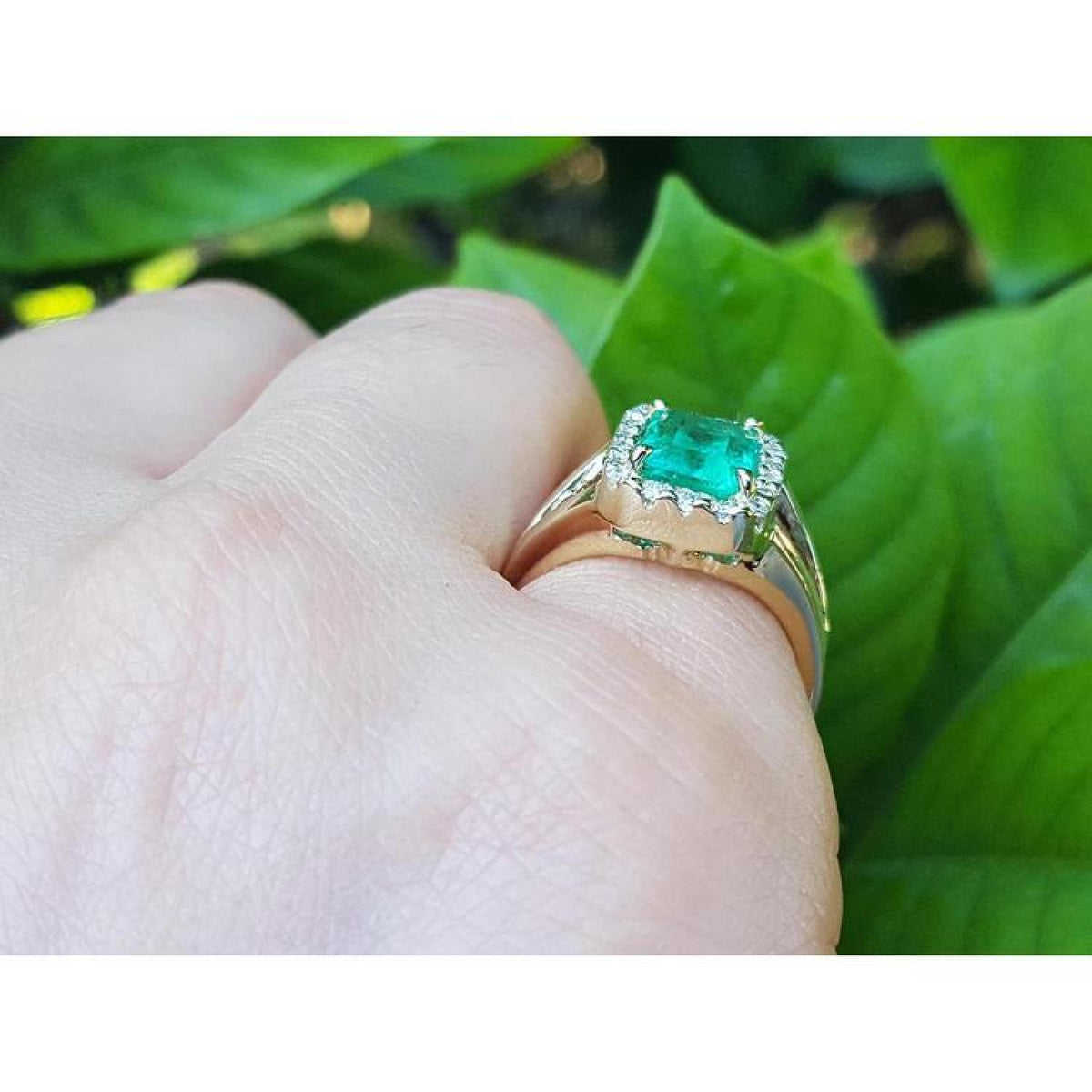 1.68 ct emerald-cut Muzo Colombian emerald ring with diamond halo, split shank 14k yellow gold.