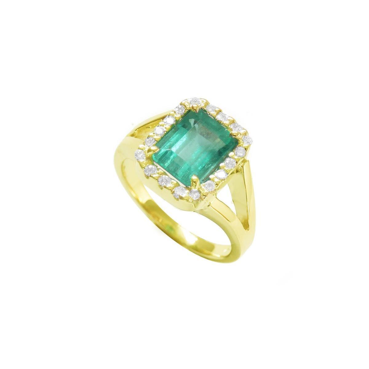 The tilted position of this halo diamond emerald ring shows the top and side profile.
