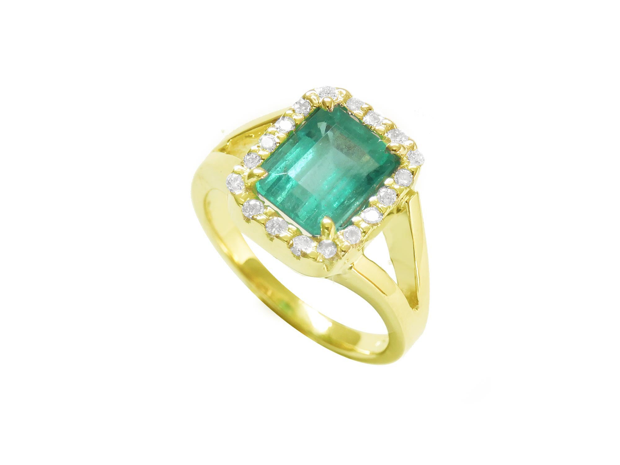 The tilted position of this halo diamond emerald ring shows the top and side profile.